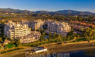 Modern garden apartment for sale in a frontline beach complex with private pool between Marbella and Estepona 25670 