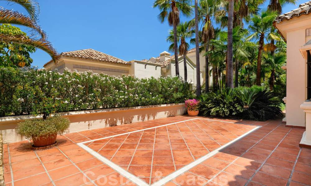 Two side-by-side luxury villas for sale on one property built in a classic Mediterranean style with stunning panoramic sea views in a gated community on the Golden Mile, Marbella 33079