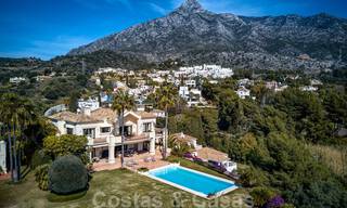 Two side-by-side luxury villas for sale on one property built in a classic Mediterranean style with stunning panoramic sea views in a gated community on the Golden Mile, Marbella 33123 