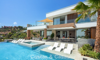 Stunning, architectural luxury villa for sale with open sea views in an elevated gated residential area in the hills of La Quinta in Marbella - Benahavis 54142 