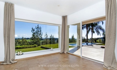 Front line golf, modern style villa for sale in Marbella - Benahavis with spectacular views to the sea, golf and mountains 