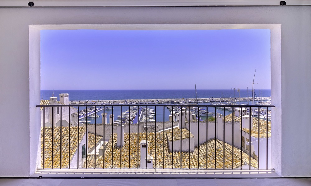 Fully renovated modern luxury apartment for sale in the marina of Puerto Banus with panoramic views over the port and the sea, Marbella. Bottom price! 12740