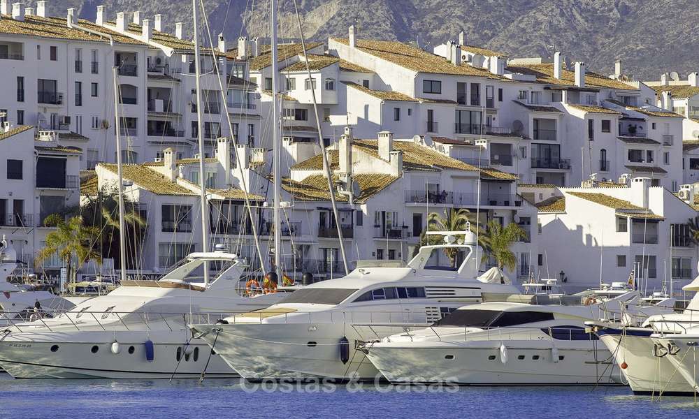 Fully renovated modern luxury apartment for sale in the marina of Puerto Banus with panoramic views over the port and the sea, Marbella. Bottom price! 12754