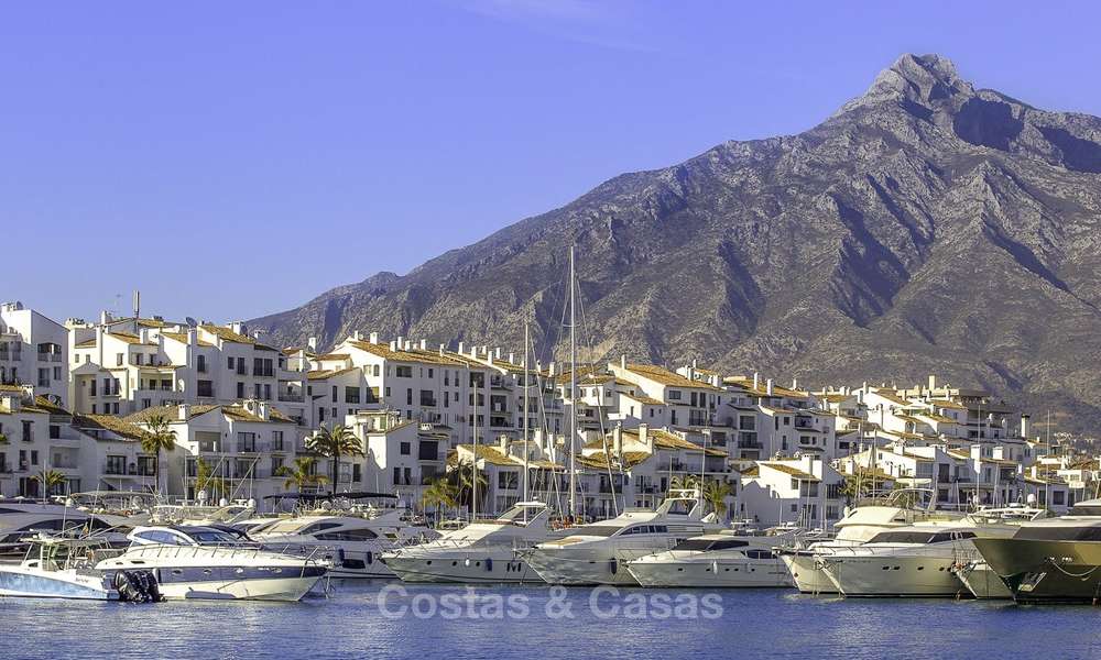 Fully renovated modern luxury apartment for sale in the marina of Puerto Banus with panoramic views over the port and the sea, Marbella. Bottom price! 12755