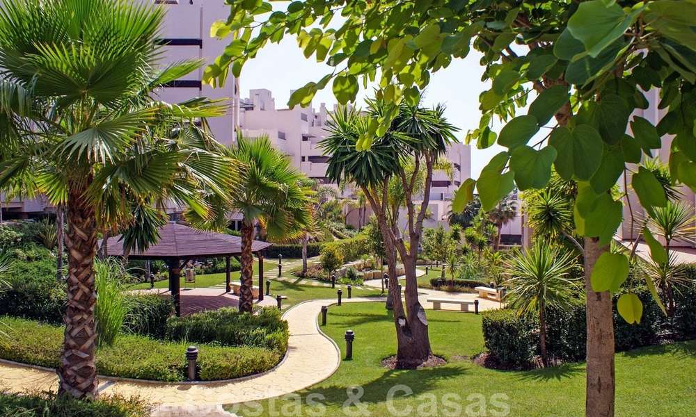 Modern garden apartment for sale in a frontline beach complex with private pool between Marbella and Estepona 25644