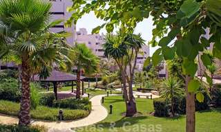 Modern garden apartment for sale in a frontline beach complex with private pool between Marbella and Estepona 25644 
