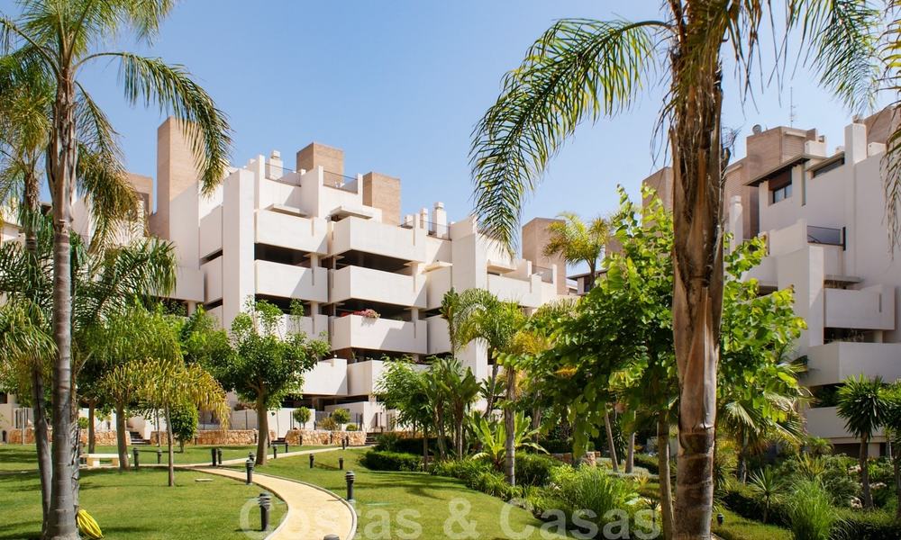 Modern garden apartment for sale in a frontline beach complex with private pool between Marbella and Estepona 25645