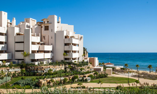 Modern garden apartment for sale in a frontline beach complex with private pool between Marbella and Estepona 25671 