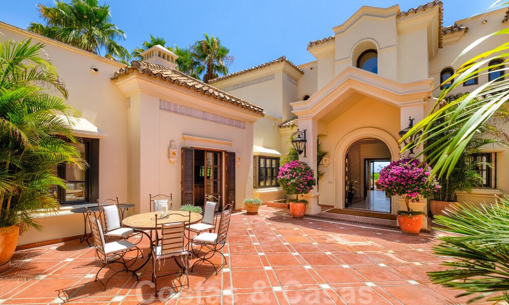 Two side-by-side luxury villas for sale on one property built in a classic Mediterranean style with stunning panoramic sea views in a gated community on the Golden Mile, Marbella 33075