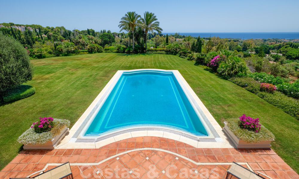 Two side-by-side luxury villas for sale on one property built in a classic Mediterranean style with stunning panoramic sea views in a gated community on the Golden Mile, Marbella 33090