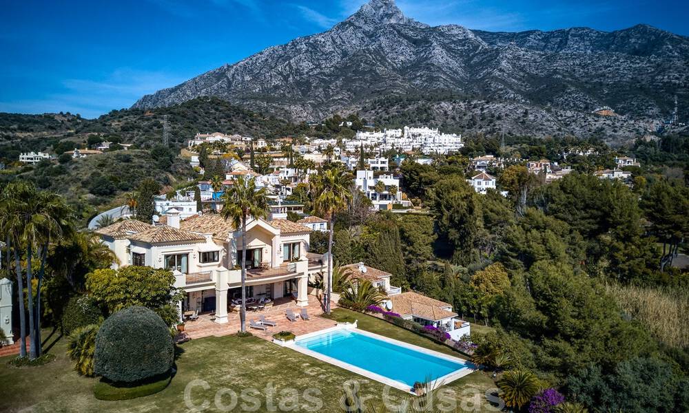Two side-by-side luxury villas for sale on one property built in a classic Mediterranean style with stunning panoramic sea views in a gated community on the Golden Mile, Marbella 33123