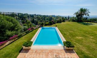 Two side-by-side luxury villas for sale on one property built in a classic Mediterranean style with stunning panoramic sea views in a gated community on the Golden Mile, Marbella 33124 