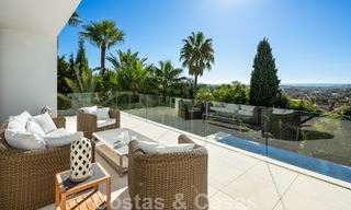 Modern luxury villa for sale located with private tennis court in prestigious residential area in Nueva Andalucia's golf valley, Marbella 50129 