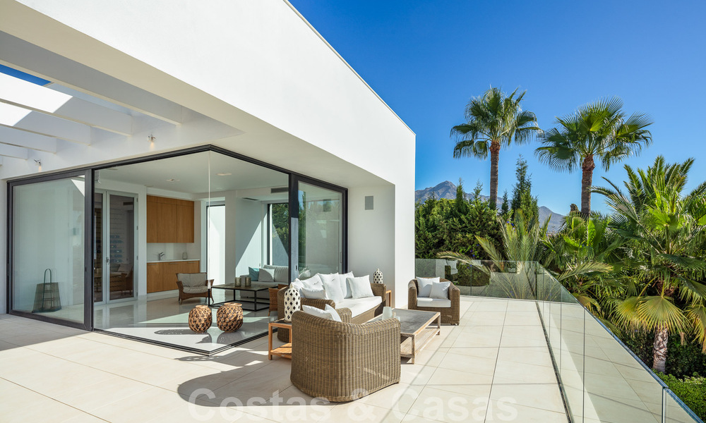 Modern luxury villa for sale located with private tennis court in prestigious residential area in Nueva Andalucia's golf valley, Marbella 50130
