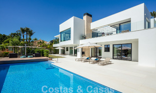 Modern luxury villa for sale located with private tennis court in prestigious residential area in Nueva Andalucia's golf valley, Marbella 50148 