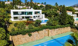 Modern luxury villa for sale located with private tennis court in prestigious residential area in Nueva Andalucia's golf valley, Marbella 50150 