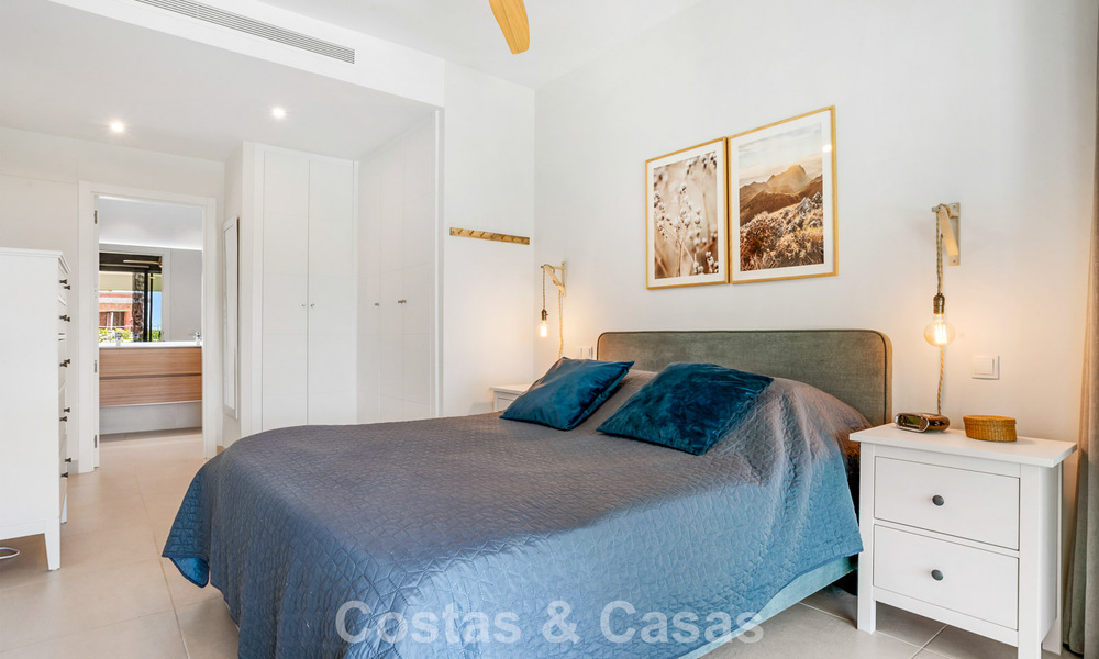 Ground-floor, modern apartment with large private garden, terrace and partial sea views for sale on golf course in Estepona 789788