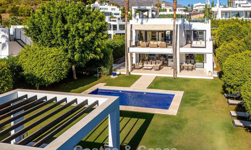 Luxury villa with contemporary architecture for sale in a gated private community of Nueva Andalucía, Marbella 794019