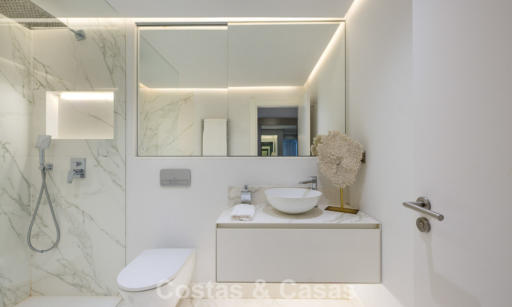Luxury apartment with private garden and sea view for sale in Los Granados, a prestigious beachfront complex in Puerto Banús, Marbella 801890